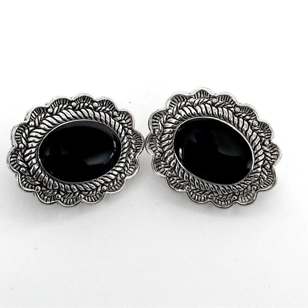 Vintage Sterling Silver Oval Clip-On Earrings with a black stone.
